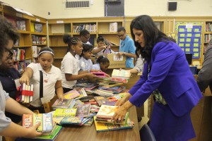 Shalini Lawson helps stack books with students