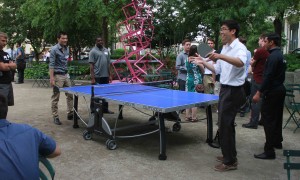 Interns play an intense game of ping pong